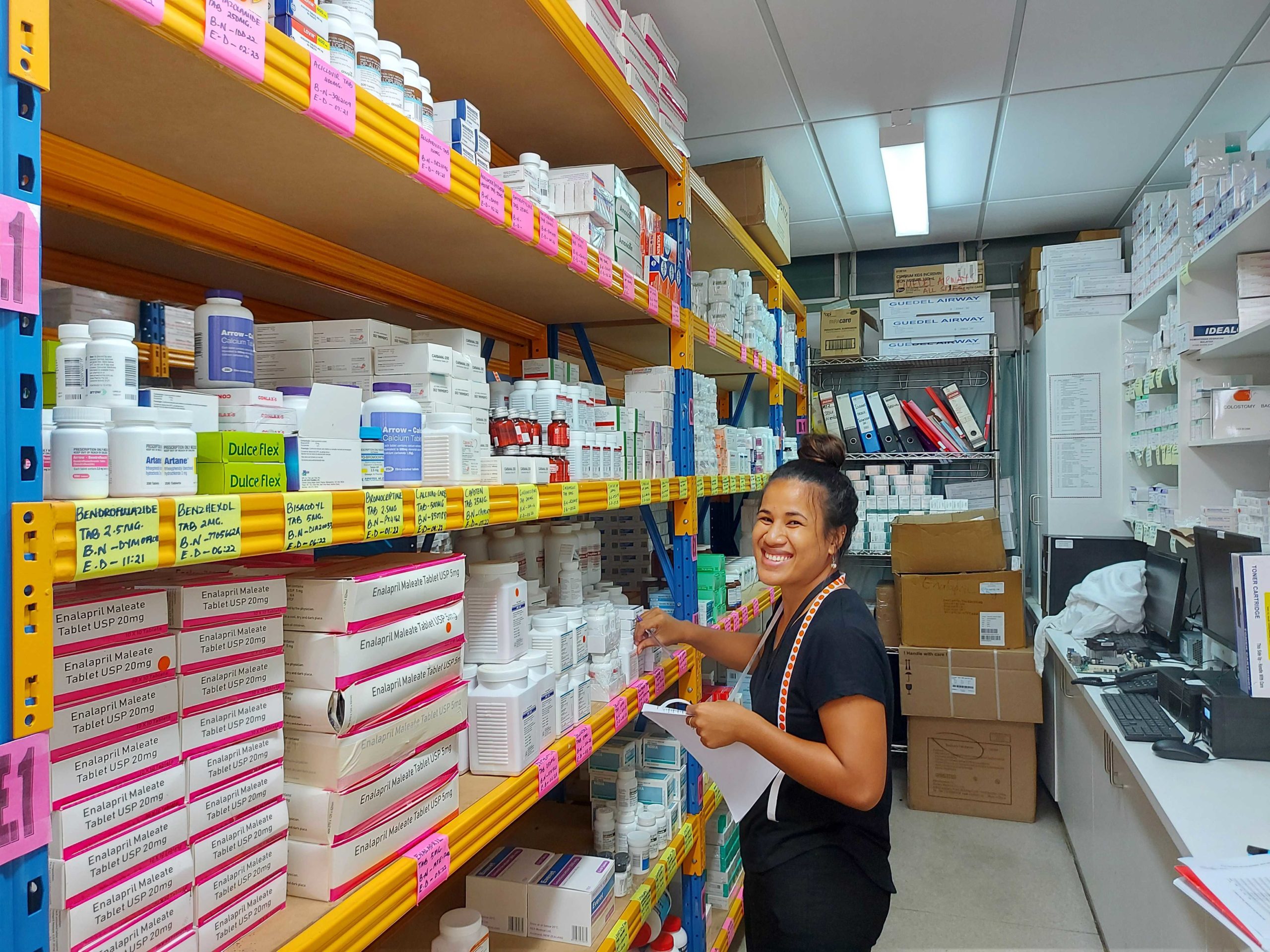 A pharmacist managing stock in a medical store