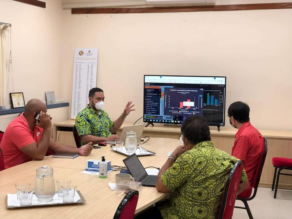 A team reviewing Tupaia dashboards on a screen